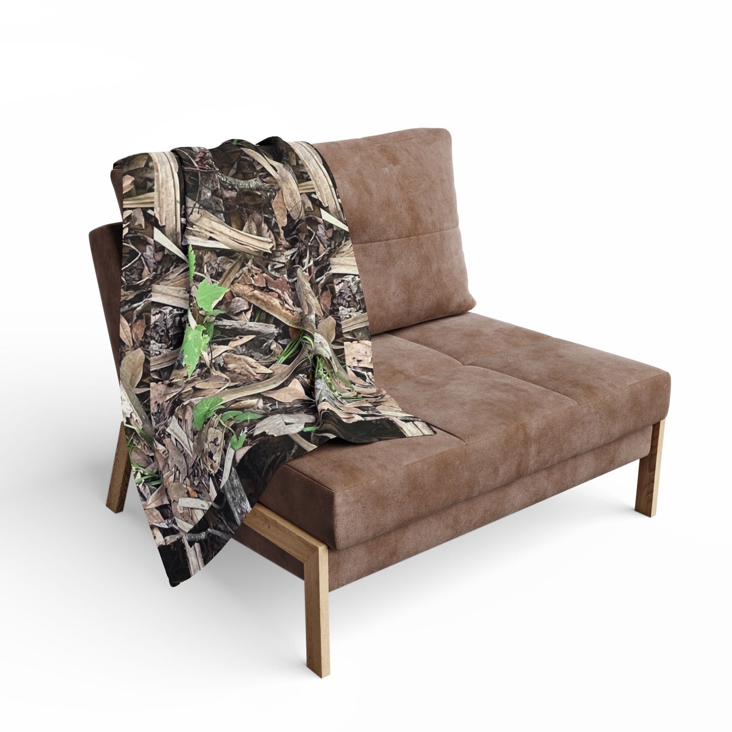 Brown sofa with a camouflage-patterned blanket draped over it on a white background