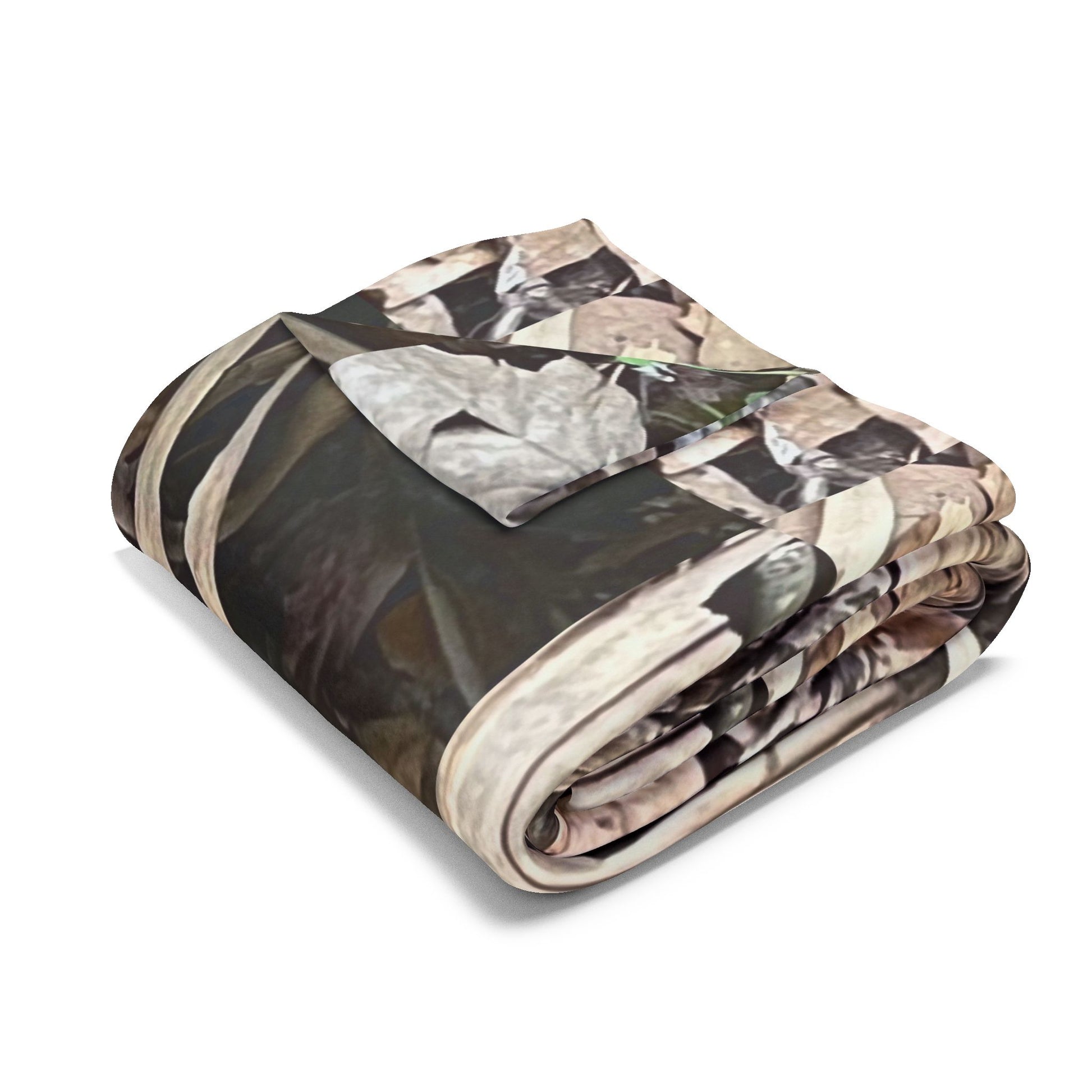 Folded camouflage-patterned blanket on a white background